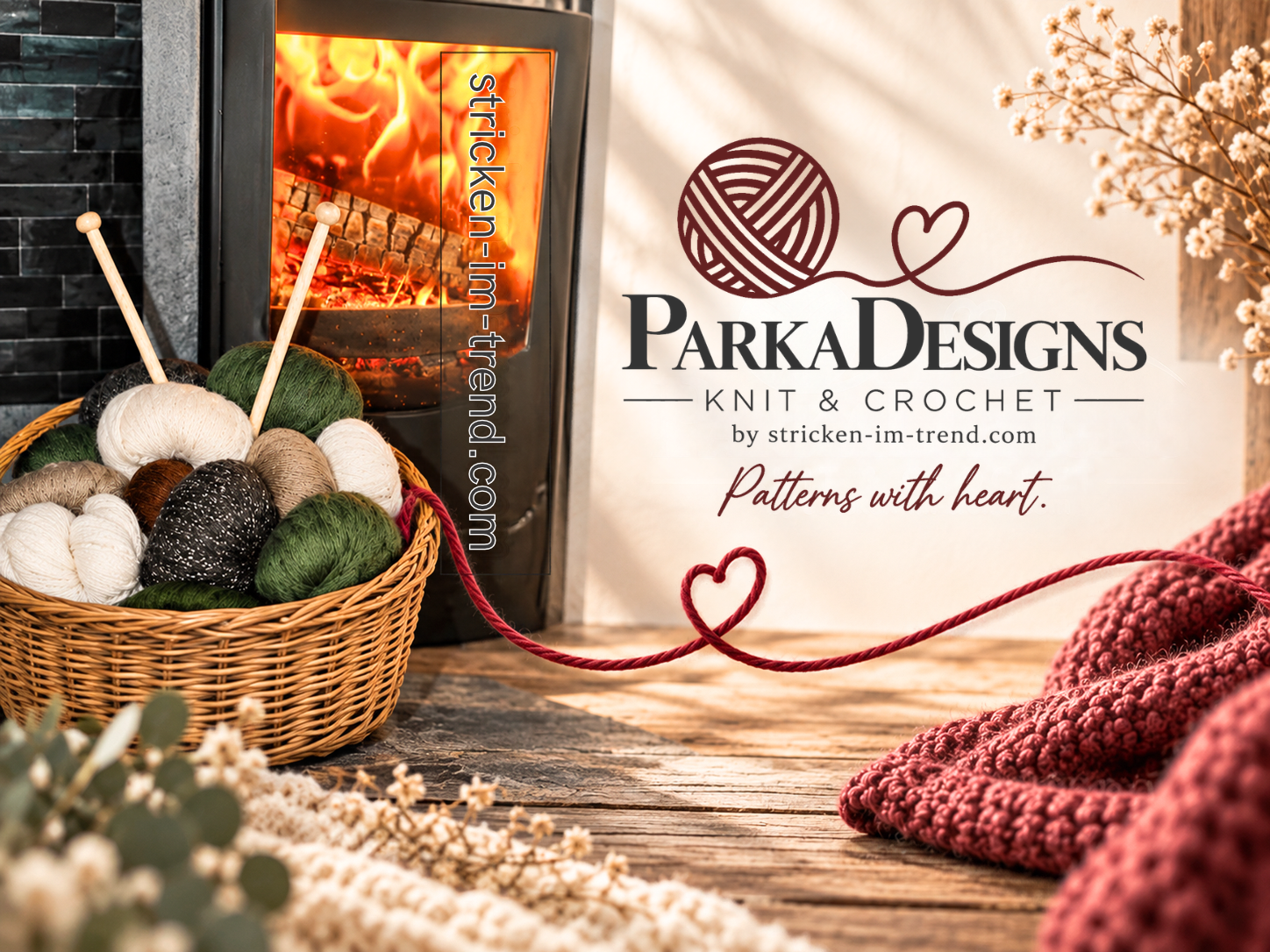 Knitting yarn balls in basket beside fireplace, with ParkaDesigns knit and crochet branding and heart motifs.